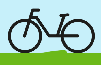 radtour-zentrum-60plus-essen-nord Fahrrad auf grüner Wiese vor blauem Himmel
